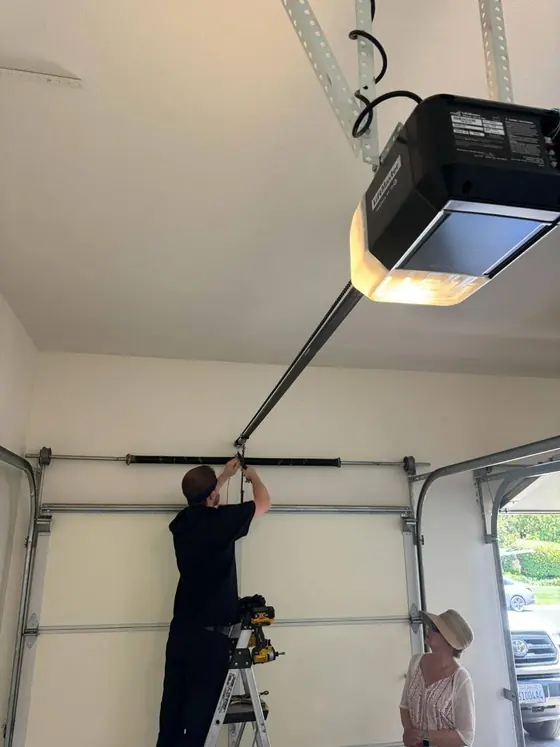 Technician installing a garage door opener